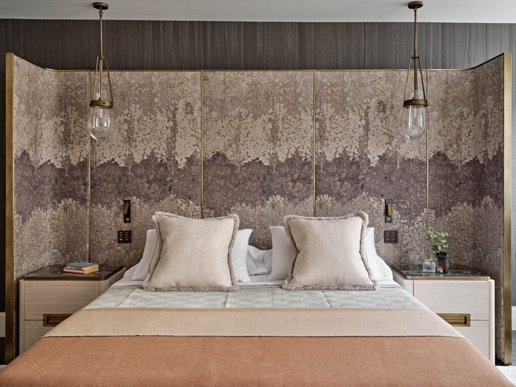 The main bedroom of a London home features a de Gournay wallcovering