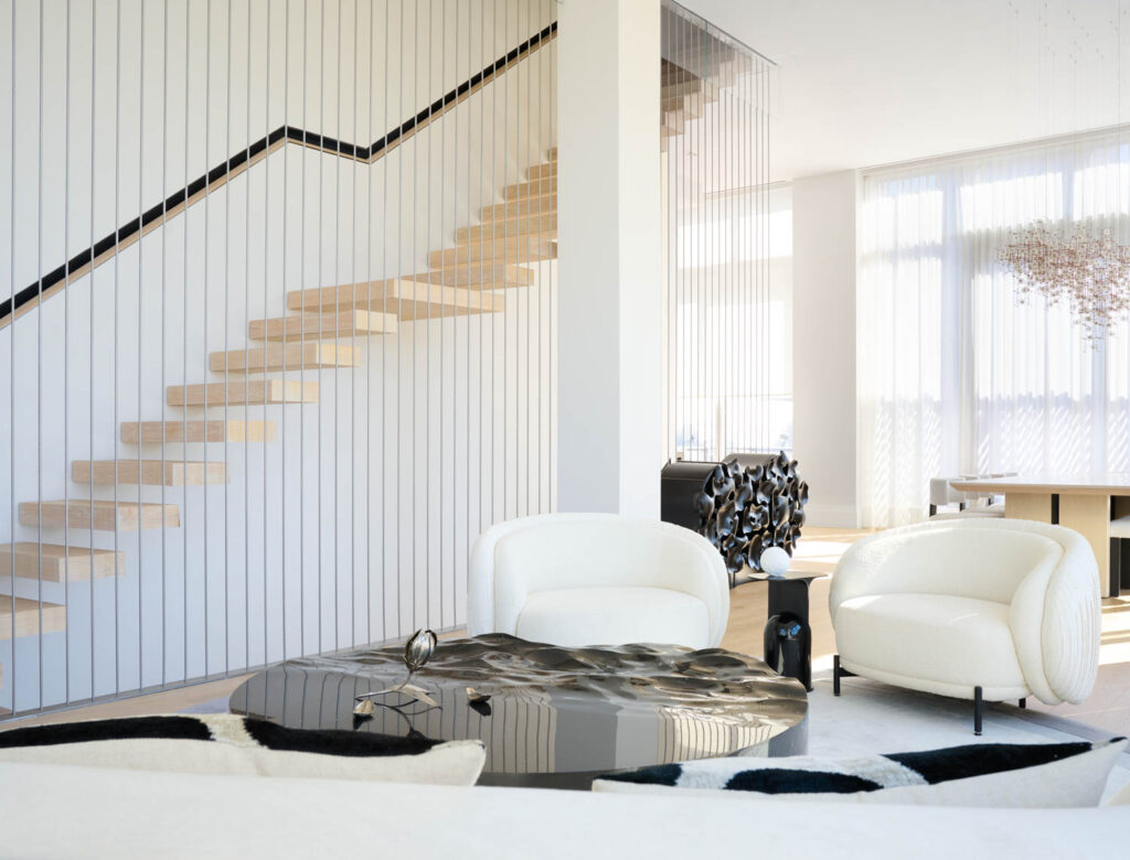 a floating staircase rises through the living room of a modern penthouse