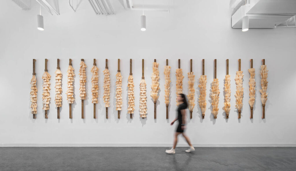 an artwork spread across the wall made of corn husks