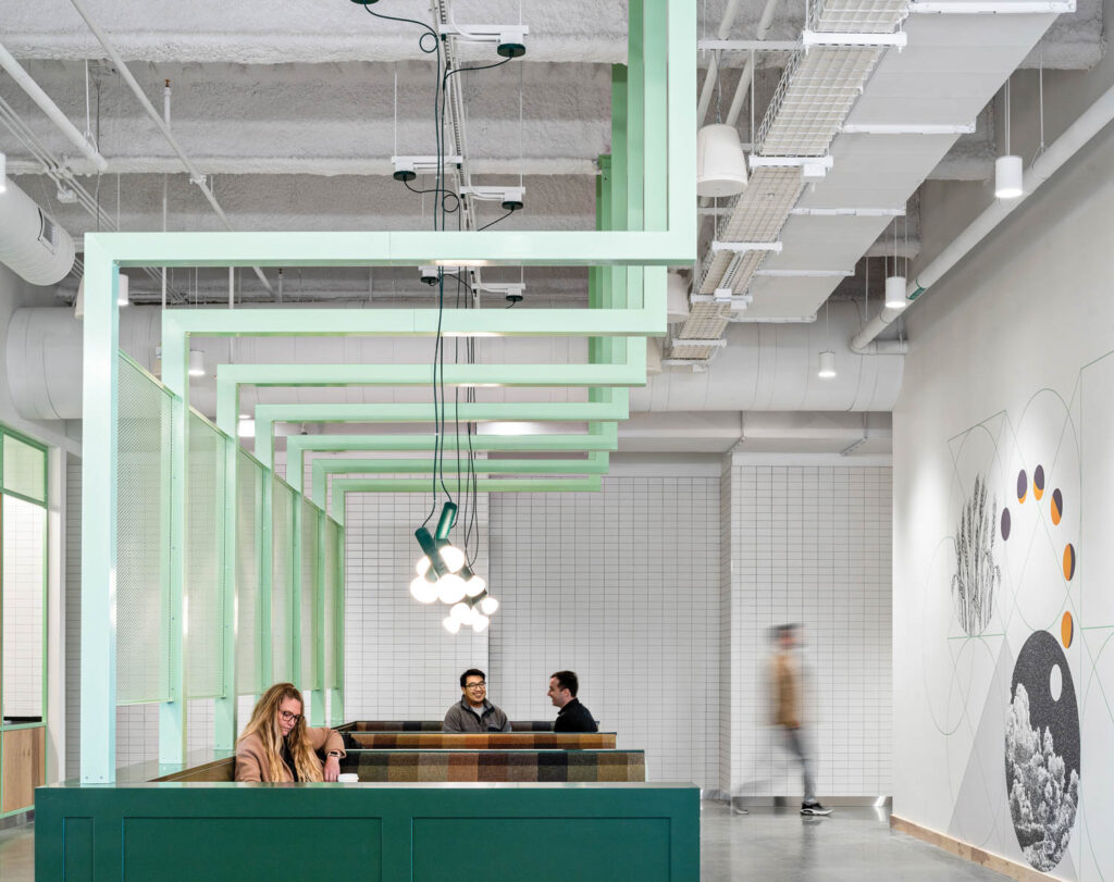 pastel green and glass partitions create individual workspaces