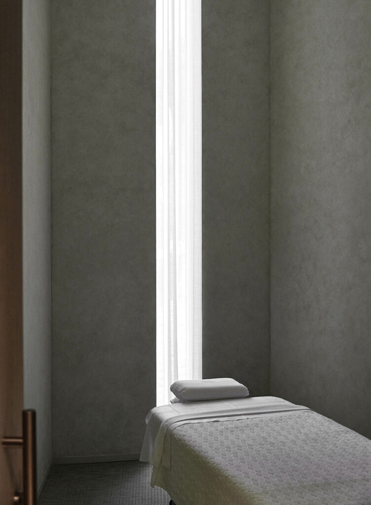 a linen curtain covers a narrow window in a treatment room