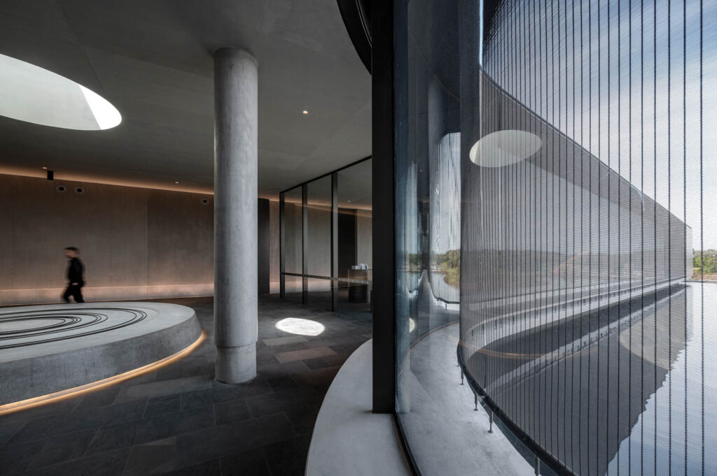 a curving tension-screen of woven steel wire wraps around a reception area