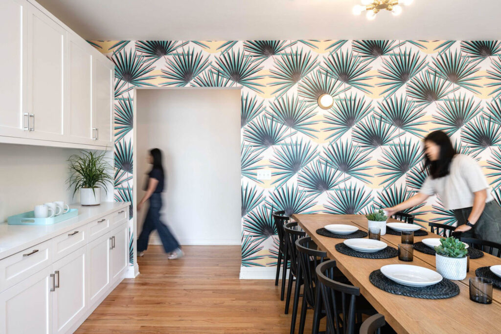 graphic wall paper of blue botanicals in front of a long dining table