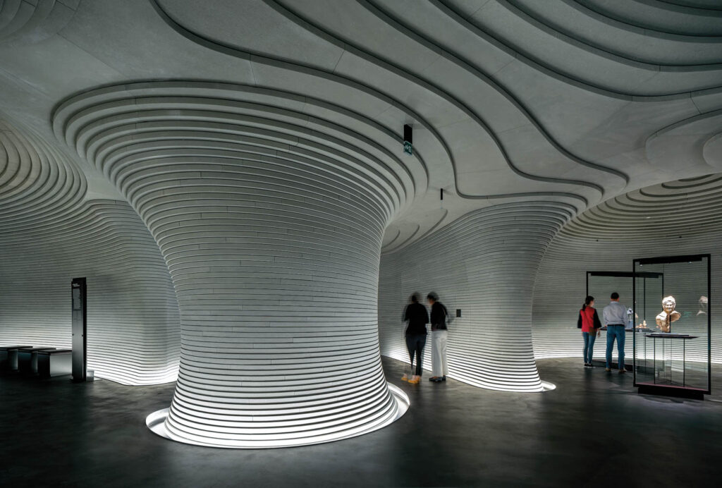 cylindrical stone columns hide HVAC systems in a museum