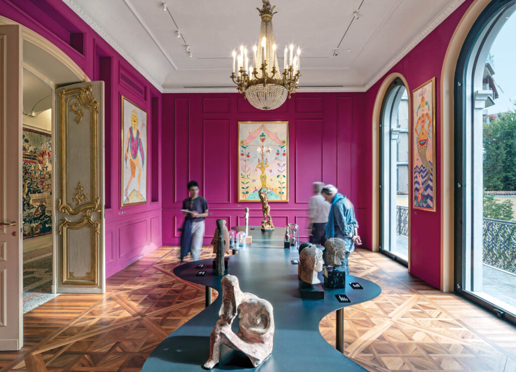 a pink walled room exhibits paintings and sculptures by Luigi Ontani 