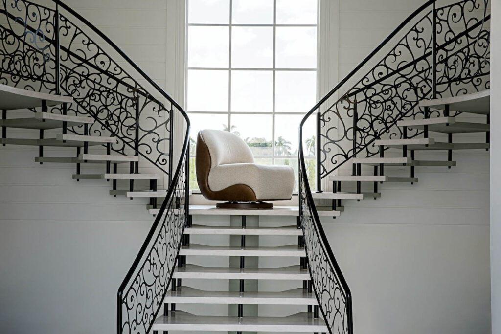 the Cuckoo armchair sits at the top of a luxurious staircase