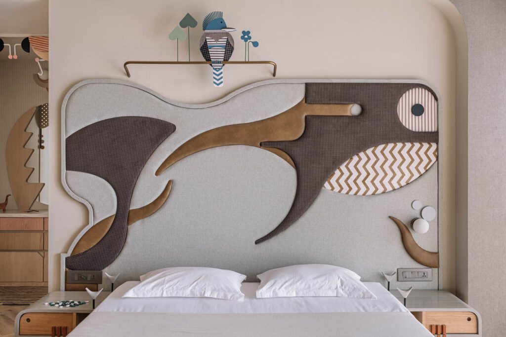 a child's bedroom with an abstract underwater-inspired headboard