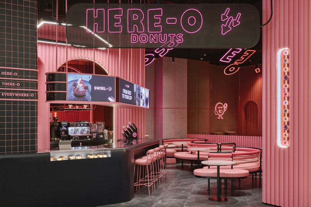 The pastel pink interior of Here-O donut shop in Dubai