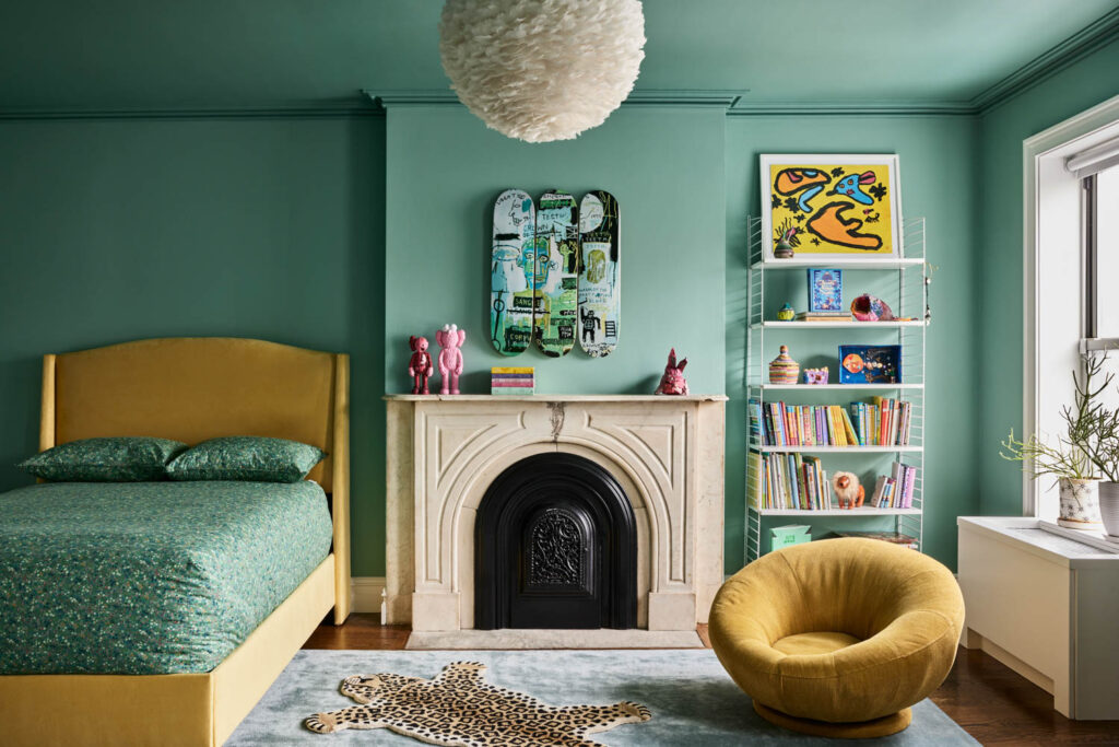 a girls bedroom with teal walls and yellow furnishings