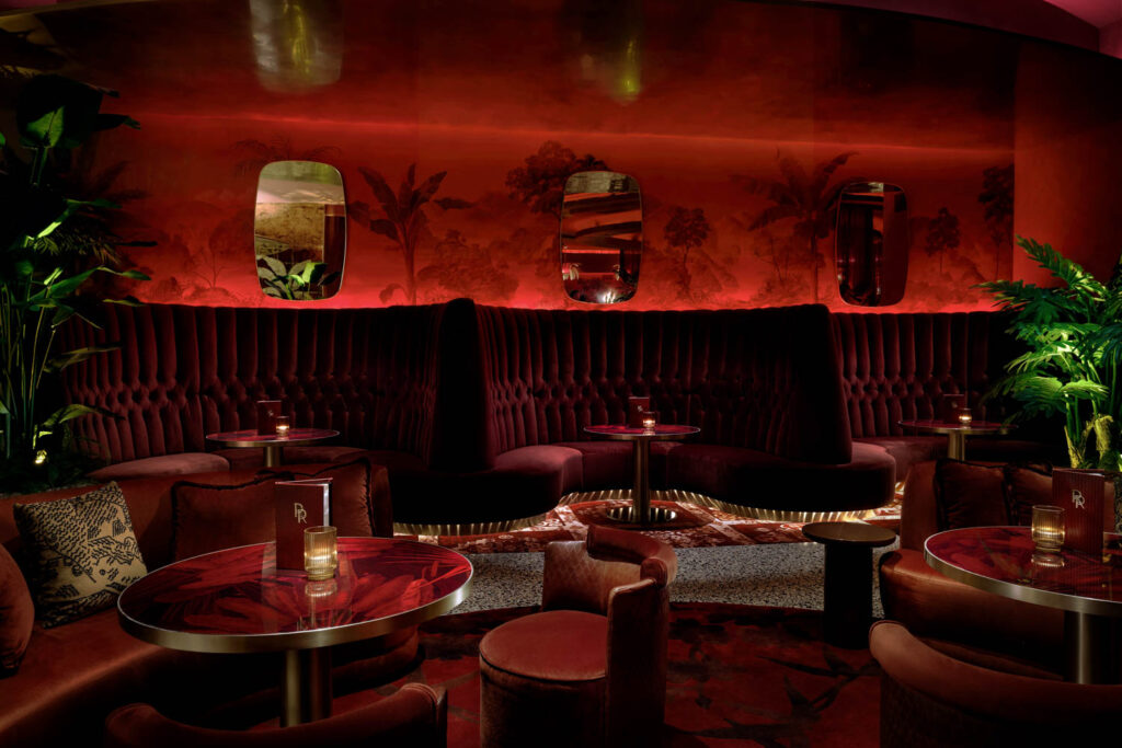 Red velvet booths inside the Rouge Room in Las Vegas